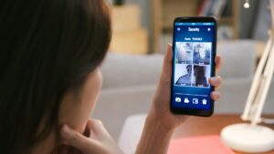 woman looking at personal security on cell phone